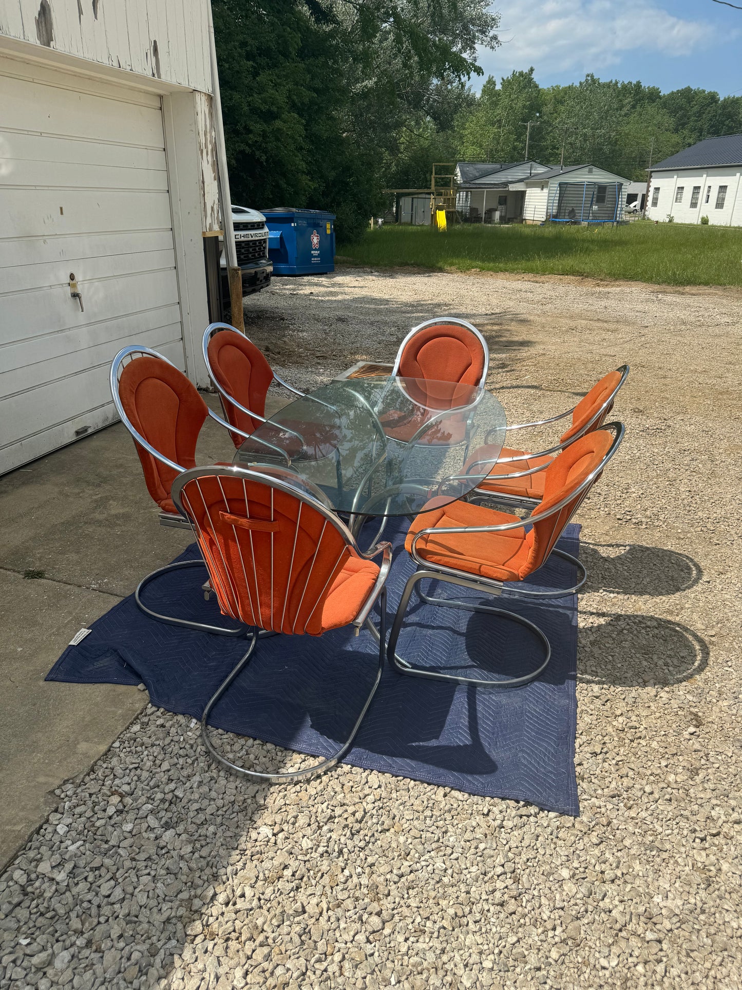 Midcentury Cantilever Dining Set - Chrome Chairs with Retro Orange Cushions and Chrome Table with Solid One-Piece Glass Top