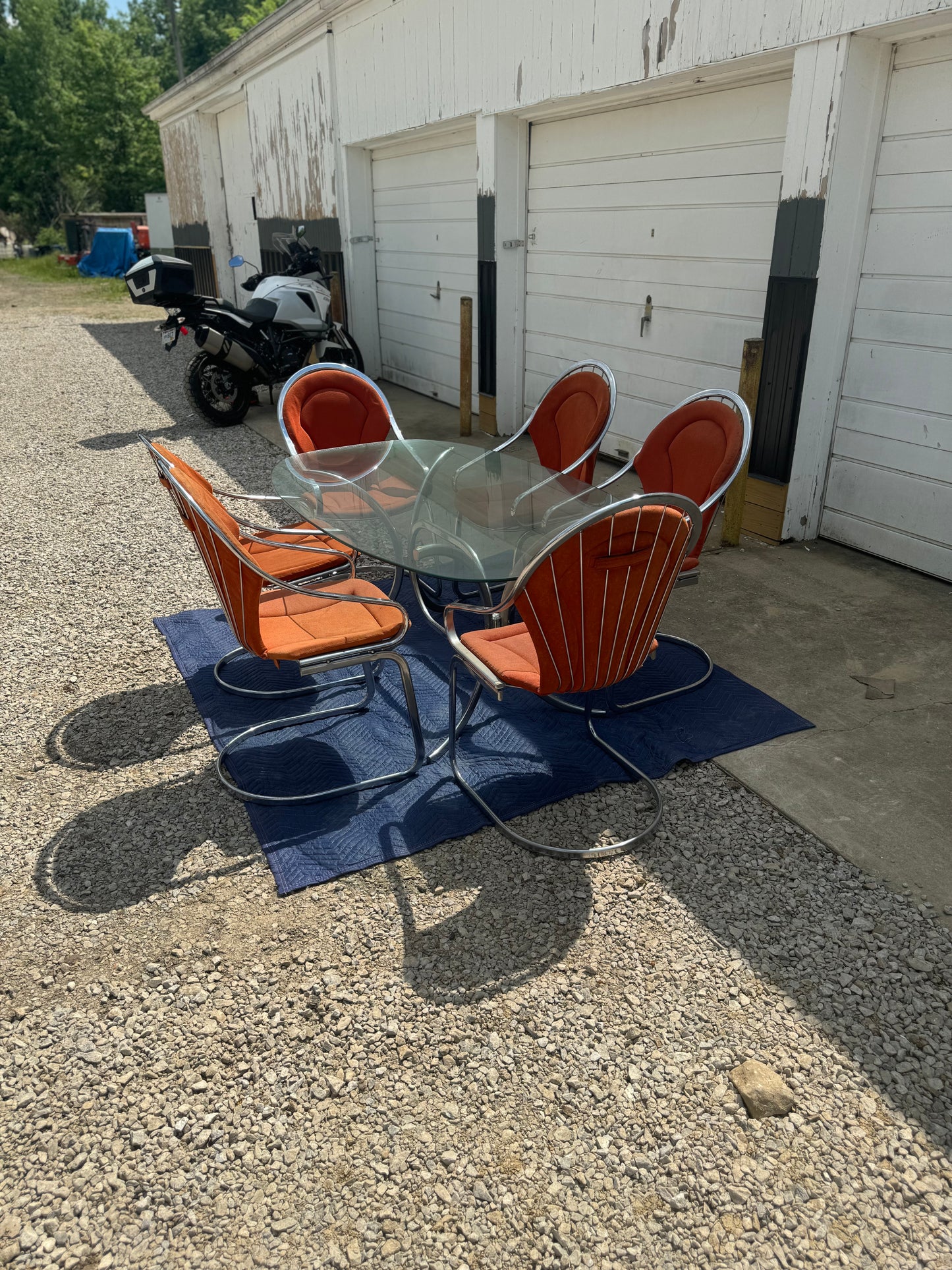 Midcentury Cantilever Dining Set - Chrome Chairs with Retro Orange Cushions and Chrome Table with Solid One-Piece Glass Top